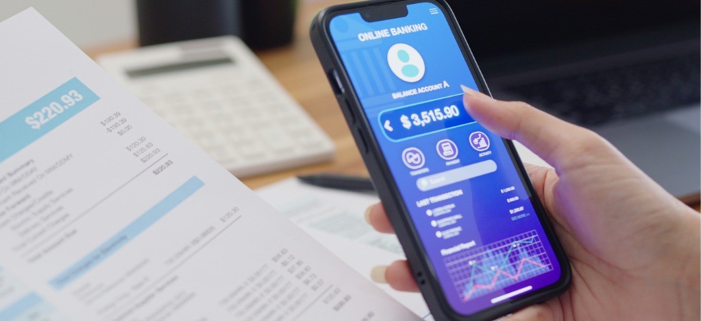 Boosting patient financial experience - A woman paying her medical bills using a digital portal on her smartphone.