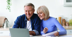 Using eBill and mailed medical statements - A senior couple comparing their mailed medical statements with an emailed medical bill.