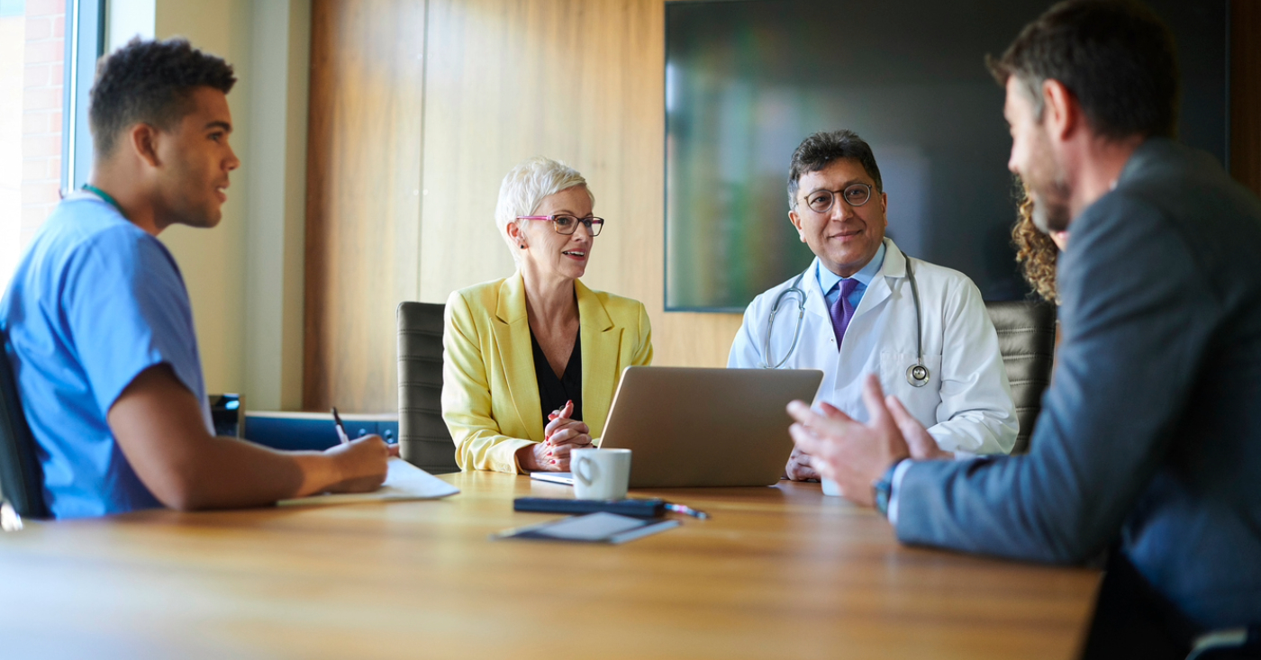 RCM company - A group of doctors and business owners having a meeting in a conference room.