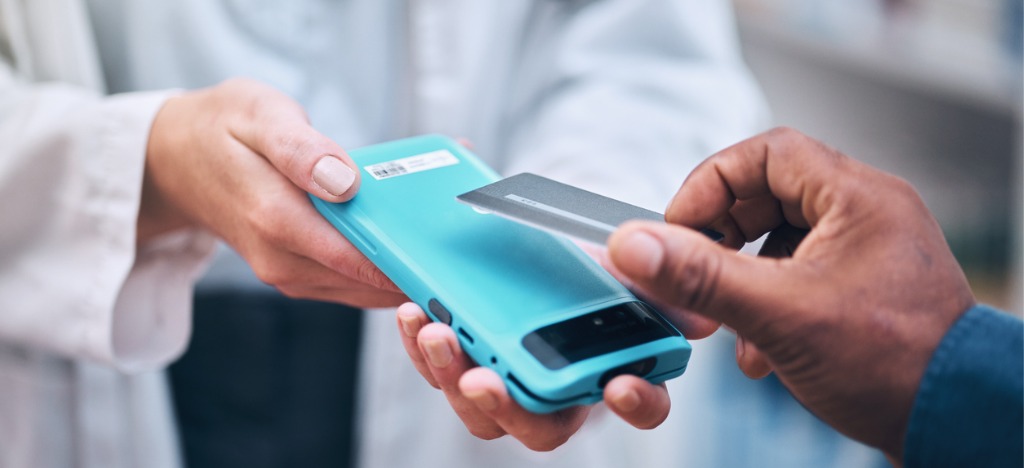 Healthcare landscape changes - A man paying his medical bills using his credit card.