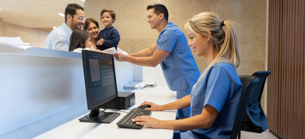 Two hospital staff members assisting a family paying for their hospital bills.