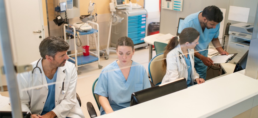 Healthcare landscape considerations - A group of medical professionals in an office working on their administrative tasks.