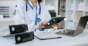 Upgrading medical billing technology - A female doctor using a tablet device showing different medical technology digital icons.