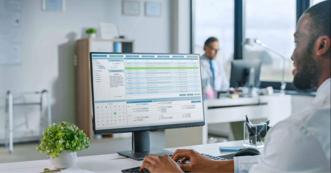 Revenue cycle vendors - A male doctor using a computer to access his practice’s billing software.