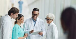 Benefits of all-in-one software for medical billing - A team of medical professionals using a tablet device to check patient billing software.
