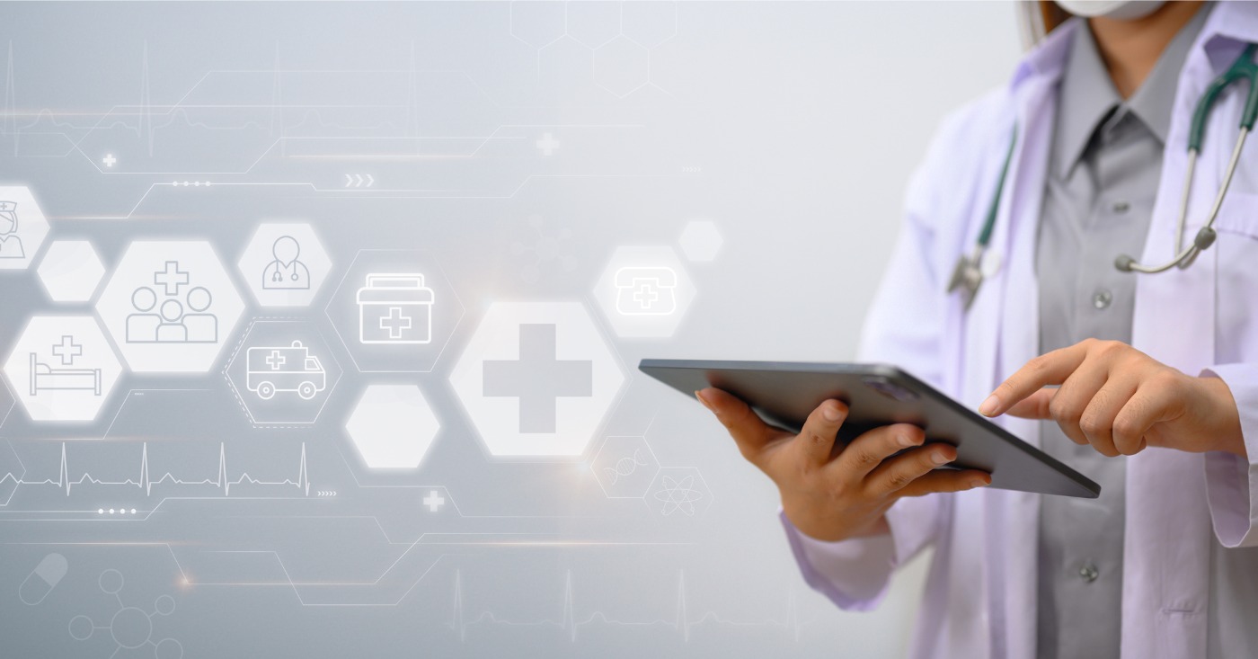 Automated billing software for medical practices - A female doctor using a tablet device showing different digital medical icons.