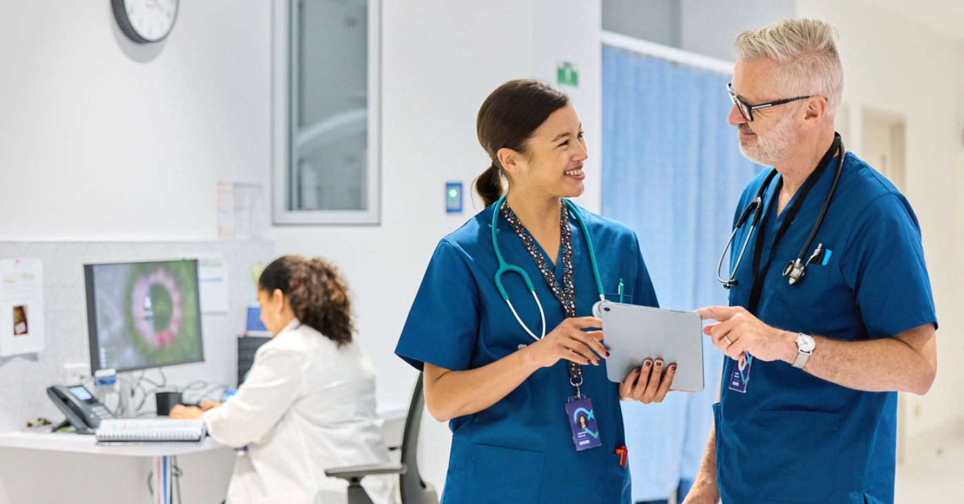Electronic Bill Presentment and Payment - Two medical doctors using a tablet device to access their practice’s billing platform.