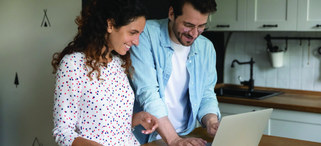 Utilizing pre-visit billing for medical practices - A couple at home checking their online medical bill using a laptop.